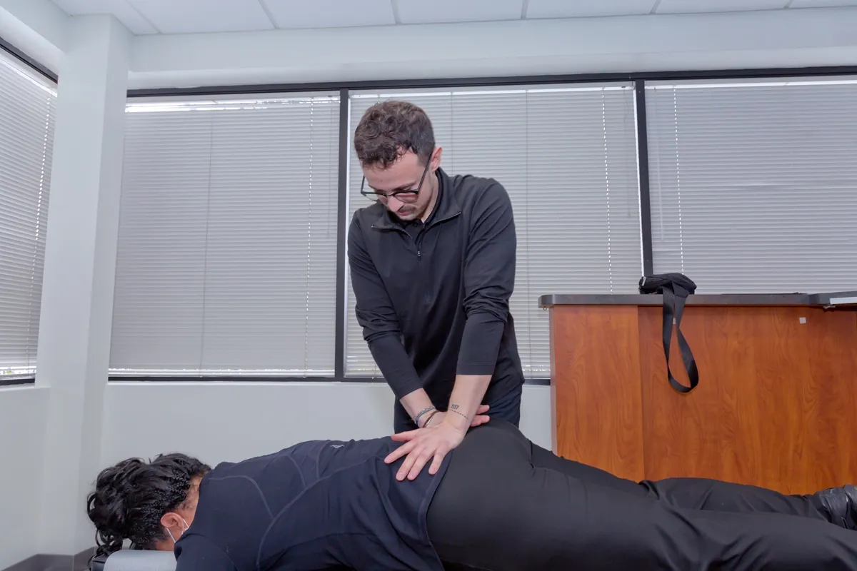 Dr. Connor Reed adjusting a patient’s lower back on a chiropractic table
