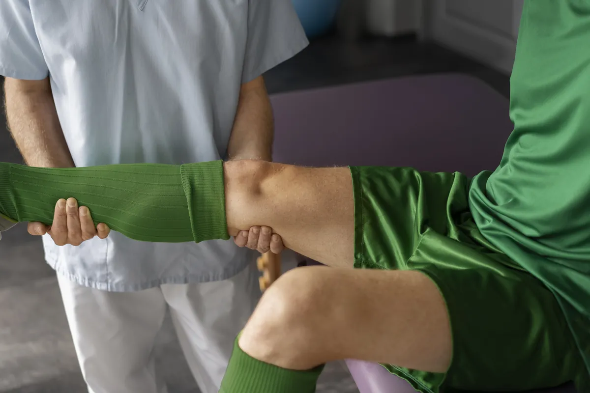 Therapist stretching a patient’s leg during sciatica therapy